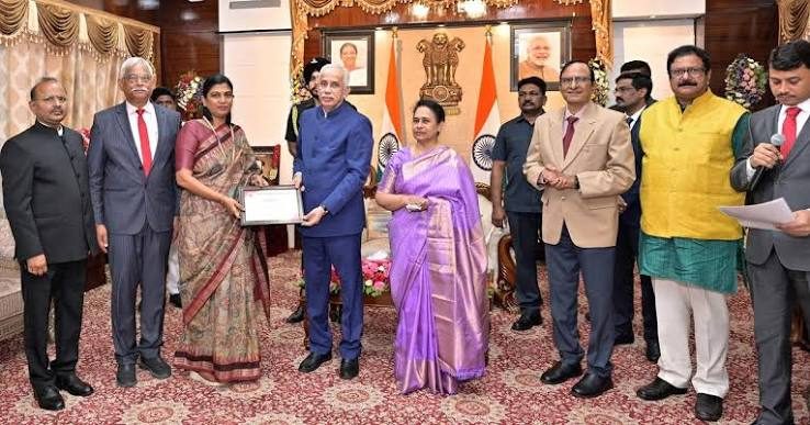 Guv Nazeer presents Red Cross gold medal to Collector Rajakumari.jpg